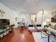 Open-concept living room with hardwood floors, dining area, and staircase at 920 Ashworth Dr, Gastonia, NC 28054