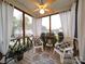 Inviting screened porch with chairs, accent table, patterned rug, and views of the neighborhood at 920 Ashworth Dr, Gastonia, NC 28054