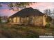 Rear view of a brick home, including a small deck area at 103 Devonshire Ln, Salisbury, NC 28146