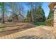 Cozy backyard with a wooden deck and outbuilding, surrounded by trees and foliage, offering privacy at 103 Devonshire Ln, Salisbury, NC 28146