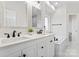 Bright bathroom featuring double vanity sinks, white cabinets, and a tub at 103 Devonshire Ln, Salisbury, NC 28146