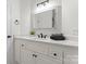 Bright bathroom featuring a white vanity with modern black fixtures and a large mirror at 103 Devonshire Ln, Salisbury, NC 28146