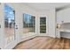 Bright breakfast nook featuring wood floors, backyard views, and built-in desk at 103 Devonshire Ln, Salisbury, NC 28146