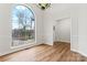 Dining room features a decorative chandelier, wood floors, and a large window at 103 Devonshire Ln, Salisbury, NC 28146