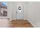 Bright entryway with decorative door, sidelight window, and wood floors at 103 Devonshire Ln, Salisbury, NC 28146