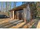 A detached one-car garage with brick facade, a drive-through and a side entry door at 103 Devonshire Ln, Salisbury, NC 28146