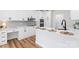 Bright, modern kitchen with white cabinets, stainless steel appliances, and quartz countertops at 103 Devonshire Ln, Salisbury, NC 28146