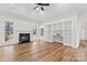 Open-concept living room features built-in bookshelves, a fireplace, and a ceiling fan at 103 Devonshire Ln, Salisbury, NC 28146