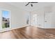 Main bedroom featuring a tray ceiling, an ensuite bathroom, hardwood floors and plenty of natural light at 103 Devonshire Ln, Salisbury, NC 28146