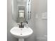 Cozy bathroom featuring a pedestal sink, modern fixtures, and a stylish mirror at 1030 Archibald Ave, Fort Mill, SC 29708