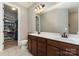 Bathroom featuring double sinks, wood cabinets, and a walk-in closet at 1030 Archibald Ave, Fort Mill, SC 29708