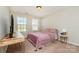 Bright bedroom features plush carpet, a double window and a wooden bedside table at 1030 Archibald Ave, Fort Mill, SC 29708