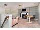 Comfortable bonus room with a modern geometric accent wall, fireplace, and cozy seating at 1030 Archibald Ave, Fort Mill, SC 29708