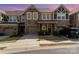 Charming townhome featuring stone accents, a one-car garage, and well-maintained landscaping at 1030 Archibald Ave, Fort Mill, SC 29708