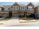 Charming townhome featuring stone accents, a one-car garage, and well-maintained landscaping at 1030 Archibald Ave, Fort Mill, SC 29708