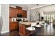 Modern kitchen with brown cabinets, granite countertops, and a large island with seating at 1030 Archibald Ave, Fort Mill, SC 29708