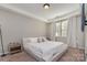 Inviting primary bedroom with plush carpeting, a tray ceiling, and natural light at 1030 Archibald Ave, Fort Mill, SC 29708