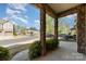 Inviting covered porch featuring stone columns, offering a pleasant neighborhood view at 1030 Archibald Ave, Fort Mill, SC 29708