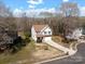 Aerial view of a lovely home with a large yard and mature trees at 105 Elk Ct, Mount Holly, NC 28120