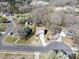 An aerial view of a home in a residential neighborhood with mature trees and landscaping at 105 Elk Ct, Mount Holly, NC 28120