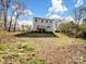 Rear view of the home showcasing the spacious backyard and deck at 105 Elk Ct, Mount Holly, NC 28120