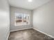 Well-lit bedroom featuring hardwood floors and large windows for ample natural light at 105 Elk Ct, Mount Holly, NC 28120