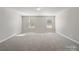 A carpeted bedroom has two windows, neutral paint and carpet at 105 Elk Ct, Mount Holly, NC 28120