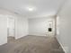 Spacious bedroom with neutral paint, plush carpet, and ample natural light from a window at 105 Elk Ct, Mount Holly, NC 28120