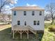 Back exterior of house showing the yard and the wooden deck at 105 Elk Ct, Mount Holly, NC 28120