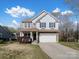 Inviting two-story home with blue shutters and a well-maintained front yard at 105 Elk Ct, Mount Holly, NC 28120
