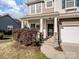 Inviting front porch with stone accents and manicured shrubbery at 105 Elk Ct, Mount Holly, NC 28120