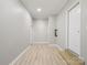 Hallway featuring wood-look floors, neutral paint, and a back door to the exterior at 105 Elk Ct, Mount Holly, NC 28120