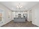 Bright open-concept kitchen with white cabinets, stainless appliances, and gray island at 105 Elk Ct, Mount Holly, NC 28120