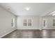 Spacious living room with large windows, hardwood floors, and neutral paint at 105 Elk Ct, Mount Holly, NC 28120