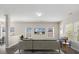 Modern living room with neutral sectional sofa, large windows, and decorative TV at 105 Elk Ct, Mount Holly, NC 28120