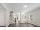 Open-concept living area features hardwood floors, staircase, and large windows at 105 Elk Ct, Mount Holly, NC 28120