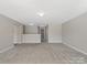 A loft space with neutral paint and carpet at 105 Elk Ct, Mount Holly, NC 28120