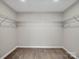 Walk-in closet with metal shelving, neutral paint, and carpeted floors at 105 Elk Ct, Mount Holly, NC 28120