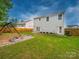 View of the home's backyard with patio, wooden fence, and swing set at 113 Devynn Ridge Ct, Mount Holly, NC 28120