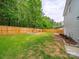 Large, fenced backyard featuring a swing set, fire pit, and pergola at 113 Devynn Ridge Ct, Mount Holly, NC 28120