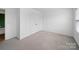 Bedroom with double closet, neutral carpet, and window providing ample natural light at 113 Devynn Ridge Ct, Mount Holly, NC 28120