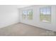 Bright and airy bedroom with plush carpeting and three windows offering pleasant views at 113 Devynn Ridge Ct, Mount Holly, NC 28120