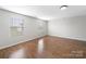 Bright bedroom features hardwood floors and abundant natural light from two large windows at 113 Devynn Ridge Ct, Mount Holly, NC 28120