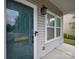 Close-up of front porch featuring a teal glass door with welcome sign, sidelight, and modern lighting fixture at 113 Devynn Ridge Ct, Mount Holly, NC 28120