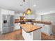 Open kitchen with stainless steel appliances, island, and decorative lighting at 113 Devynn Ridge Ct, Mount Holly, NC 28120