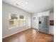 Eat-in kitchen area with stainless steel refrigerator, white cabinetry, and two windows at 113 Devynn Ridge Ct, Mount Holly, NC 28120