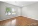 Light-filled space with wood-look floors, white walls, a window, and a white door at 113 Devynn Ridge Ct, Mount Holly, NC 28120