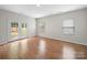 Bright living room with wood-look floors and glass patio doors leading to backyard at 113 Devynn Ridge Ct, Mount Holly, NC 28120