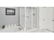 Bathroom featuring a large tub, glass shower, and tile accents at 11333 Snapfinger Dr, Charlotte, NC 28277