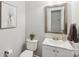 Well-lit bathroom with modern vanity, framed mirror, and neutral color scheme at 11333 Snapfinger Dr, Charlotte, NC 28277